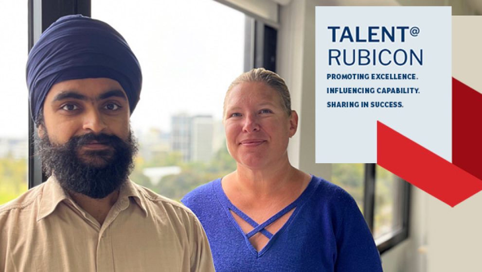 Photo of Tara and Hermandeep, new starters at Rubicon Associates, in front of the window at Melbourne office
