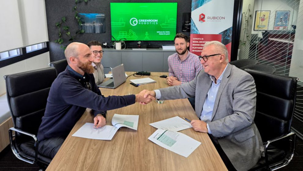 CEOs of Rubicon Associates and Greenroom Robotics shaking hands with signed agreement